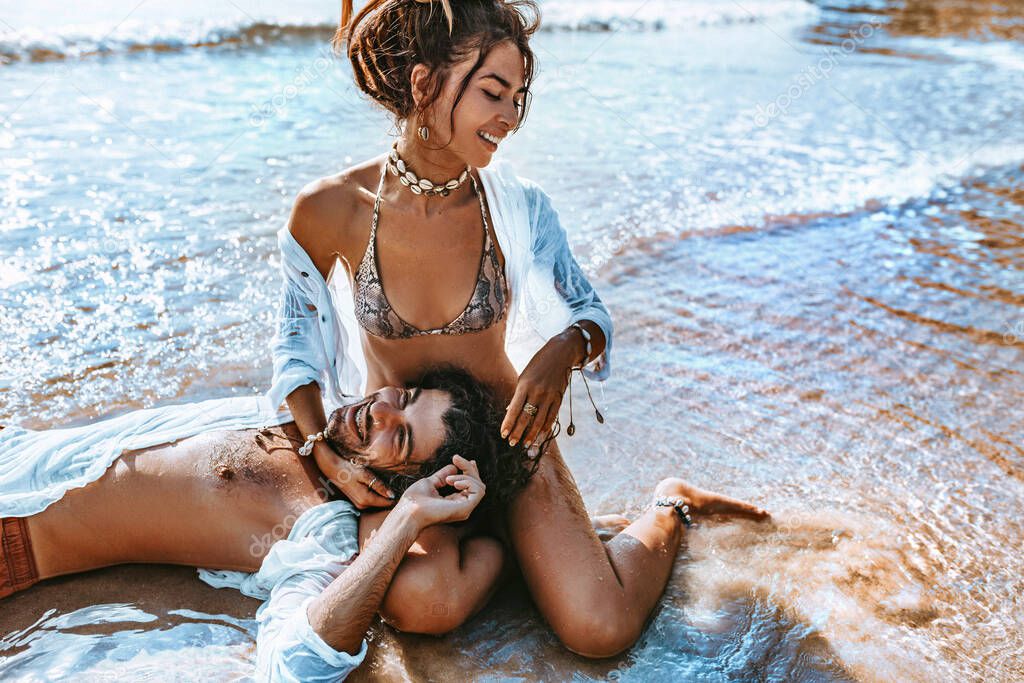 close up of beautiful young couple having fun at the beach