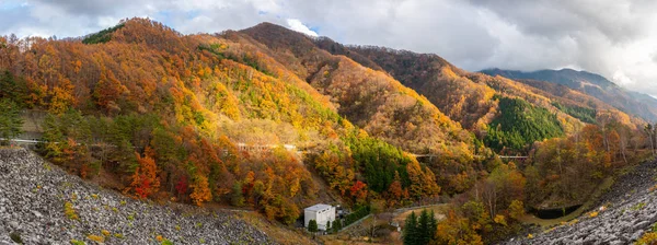 Panorama view of beautiful autumn with fog on mountain along country road in Japan
