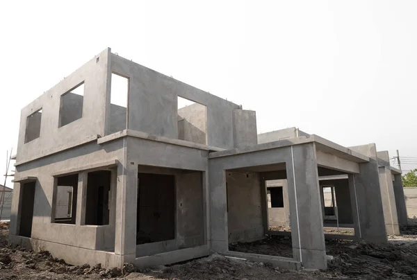 Ev yapım aşamasında bir bina sitesi, göl kenarında beyaz arka plan üzerinde.