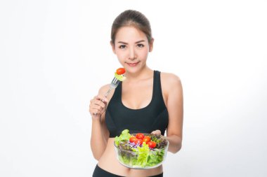 Bir fitness süitinde kız bir salata kase tutar.