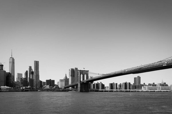View of Manhattan with the Brooklyn Bridge highlighted in black and white.