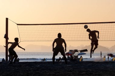 Plajda footvolley oynayan genç grup