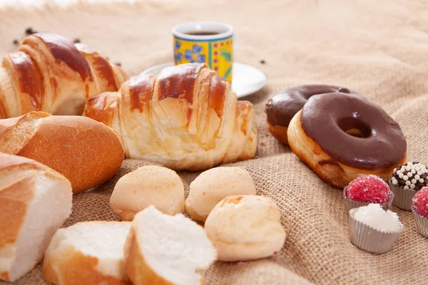 Breakfast with Italian bread, cheese bread, chocolate donut, cof