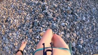 Bikinili genç kadın sahile doğru denize doğru adım attı.