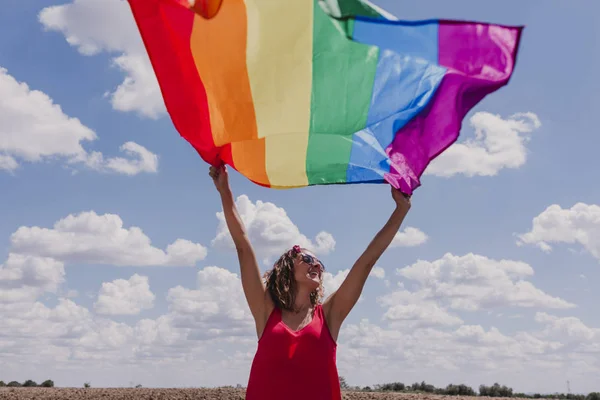 Mujer Sosteniendo Bandera Del Arco Iris Gay Sobre Cielo Azul — Foto de Stock