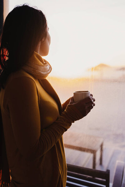 Woman Enjoys Fresh Coffee Sunset Beach Terrace Indoors Lifestyle Stock Photo