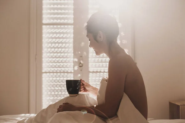 Naked Woman Covered White Sheets Sitting Bed Enjoying Cup Coffee Stock Picture