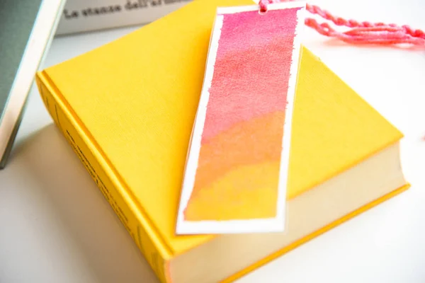 colorful bookmark on a closed yellow book. education. reading.
