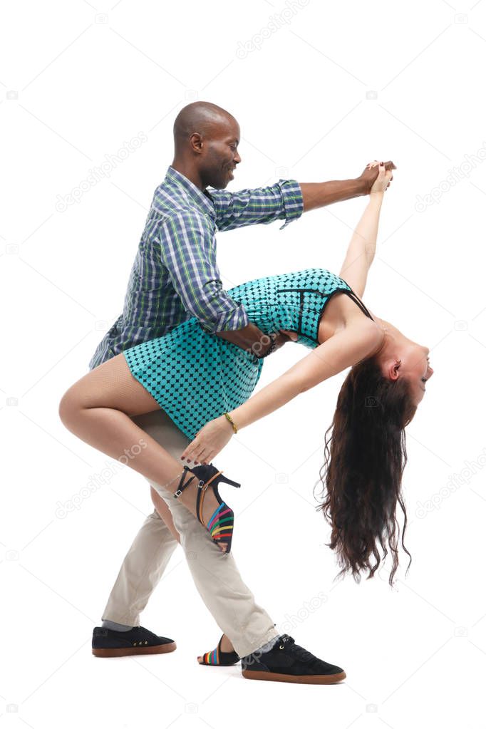 Black man and caucasian woman in casual clothes in incendiary dance isolated on white background.