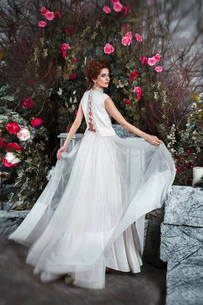 Luxurious bride in flowing dress in mysterious garden