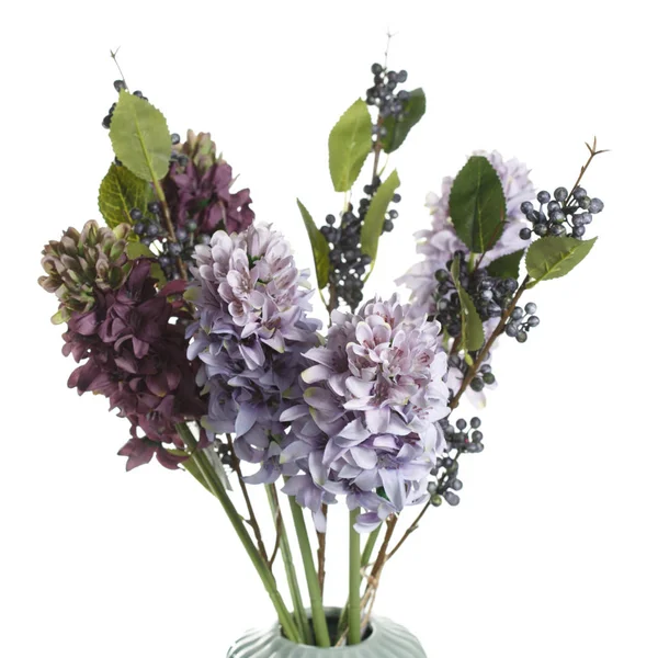 Bouquet of artificial lilac in a vase isolated on white background.