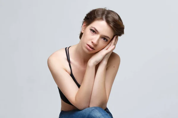 Emotional portrait of upset woman isolated on gray background.