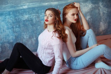 Genç kadın bakarak Studio fotoğraf makinesi üzerinde mavi arka plan