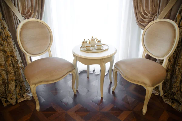 Dwa Krzesła Stolik Klasycznej Stele Zestawem Herbaty Oknie — Zdjęcie stockowe