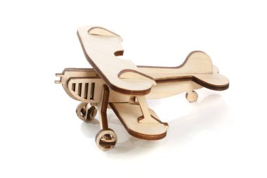 Wooden toy model of a corn dug plane isolated on a white background.