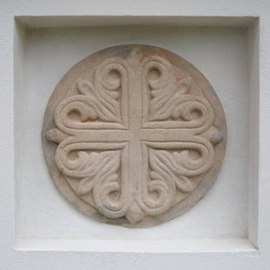 Beyaz bir duvarda yuvarlak dekoratif kabartma.