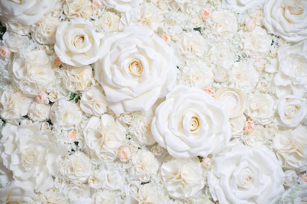 Delicate wedding floral wallpaper made of artificial beige roses.