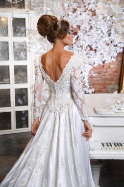 Arkasından iç mekan görünümlü muhteşem elbisesi olan zarif gelin..