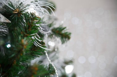 Yeni yıl duvar kağıtları, yapay süslemeli bir Noel ağacının bir parçası. Işıklardan gelen bokeh 'in arka planında..