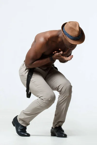 Athletic black man dancing, on a white background.