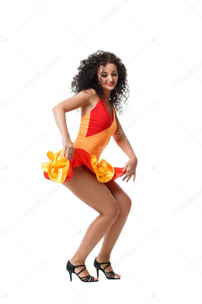 Beautiful brunette girl with magnificent curls dancing salsa Isolated on a white background.