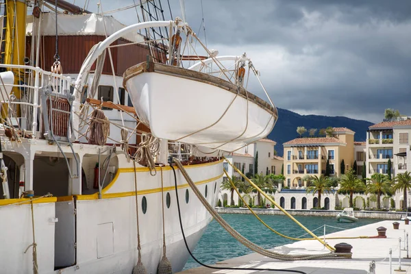 A fragment of a white sailboat with a rescue boat on board in the city of Tivat, Montenegro.