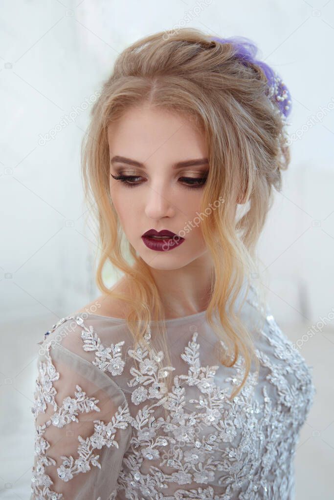 Delicate portrait of a cute bride girl with an air crochet with colored hair strands and bright make-up.