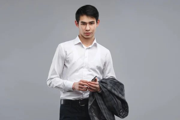 Young Asian Man White Shirt Holding Jacket Isolated Gray Background — Stock Photo, Image