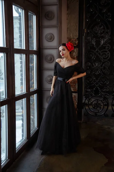 在皇宫里 穿着黑色长裙 头戴红花 美丽的黑发姑娘 — 图库照片