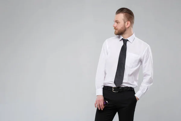 Stylish white man in casual office wear isolated on a gray background.