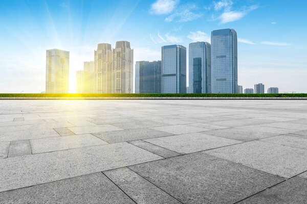 Empty Plaza floor tiles and the skyline of modern urban building