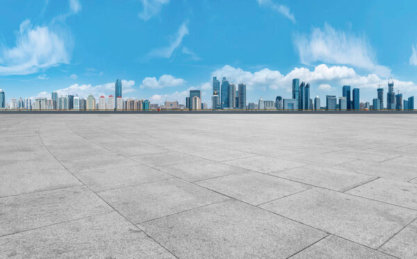Empty marble floors and city views under the blue sky