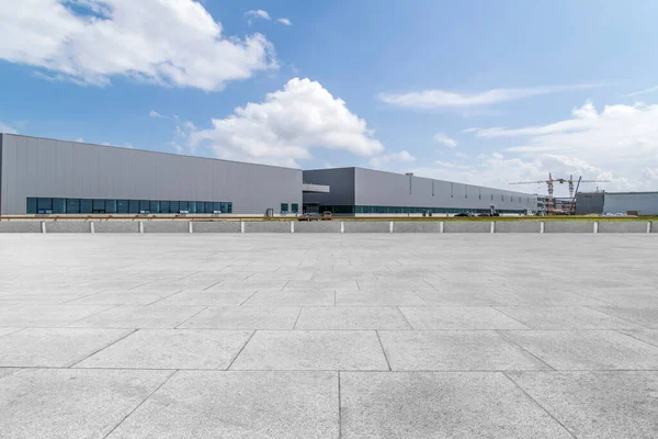 Boş kare döşemeler, modern fabrika binaları ve ambar.