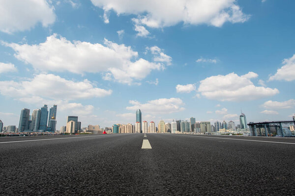 Empty asphalt road along modern commercial buildings in China,s