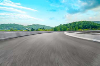 Boş asfalt yol ve mavi gökyüzünün altındaki doğal manzara