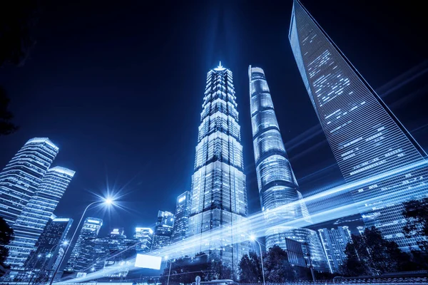 Shanghai city buildings at night and blurred car lights