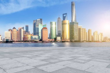 Blue sky, empty marble floor and skyline of Shanghai urban archi clipart