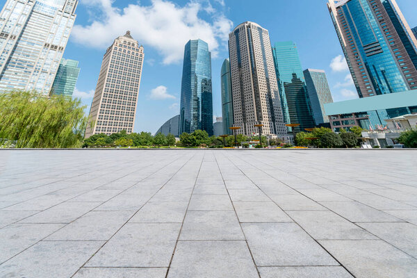 Puty square floor tiles and skyline of modern urban buildings i
