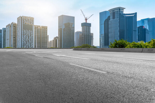 City skyscrapers and road asphalt pavement