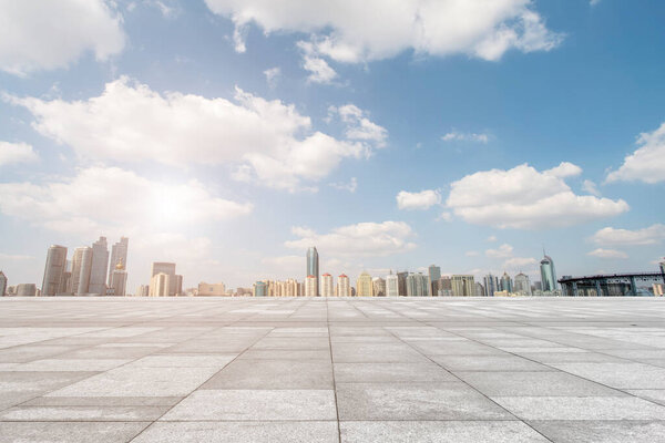 Empty marble floors and city views under the blue sky