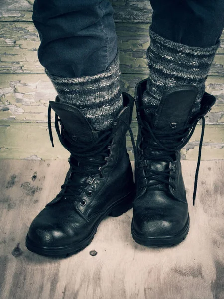 Close Legs Wool Socks Rough Black Scratched Boots Standing Wooden — Stock Photo, Image