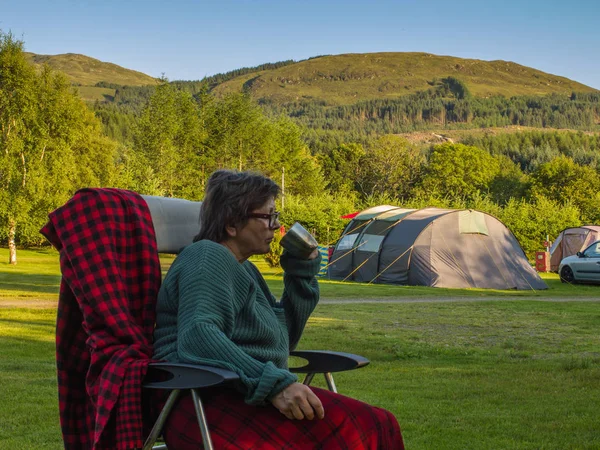 Senior adventurer 55-60 years resting at the campsite of Scotlan Stock Image