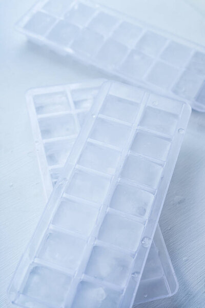 Ice molds with frozen ice from the freezer.