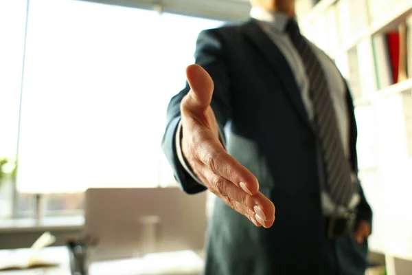 Man in suit and tie give hand as hello — Stock Photo, Image