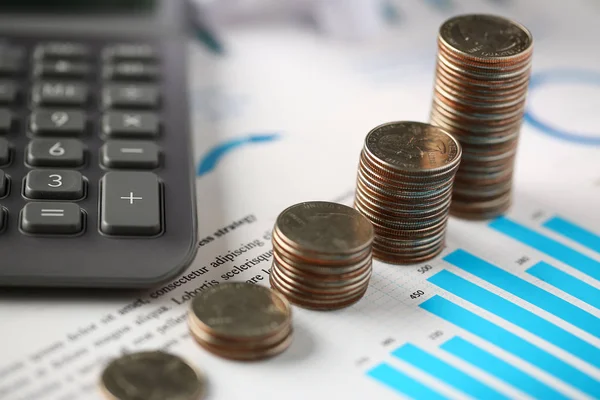 Pile of silver coins stand at financial graph papers — Stock Photo, Image