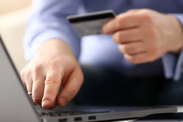 Male arms hold credit card press buttons making transfer — Stock Photo, Image