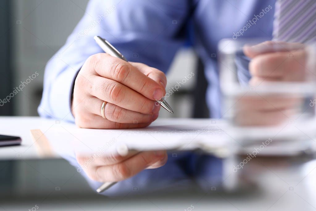 Arm fill and sign important form clipped to pad with silver pen