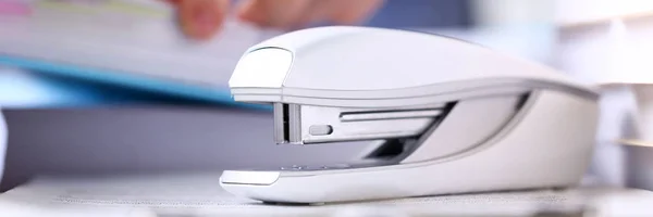 Big grey stapler stand at clipboard pad with clerk arms — Stock Photo, Image