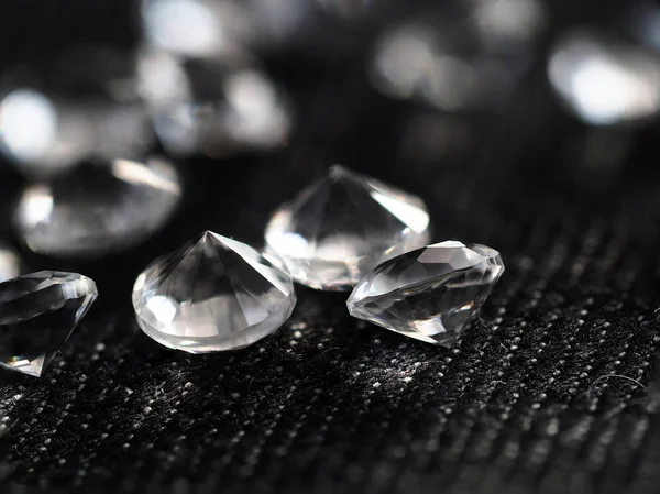 Pile of diamonds lying down at black textile