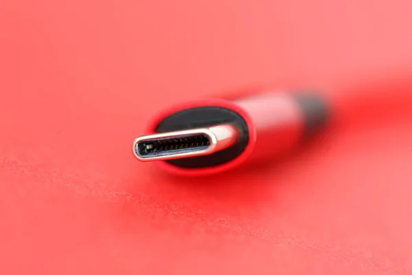 Red usb cable end lying on table